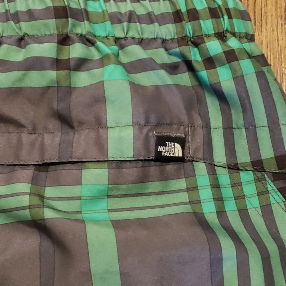 The north face green and gray lined swim trunks